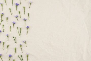 Purple cutter flowers pattern on white muslin fabric with copy space