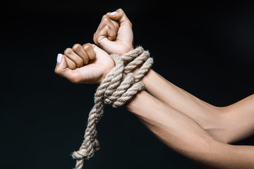 Fototapeta na wymiar female hands bound with rope