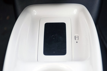 Wireless smartphone charger in the new car. © vpilkauskas