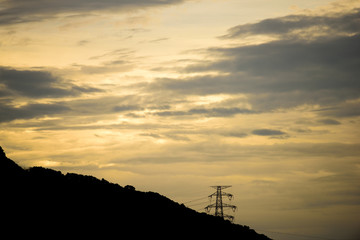 The silhouette of the evening electricity transmission pylon in Hong Kong