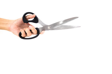woman left hand holding black plastic handle of silver blade scissors on white background