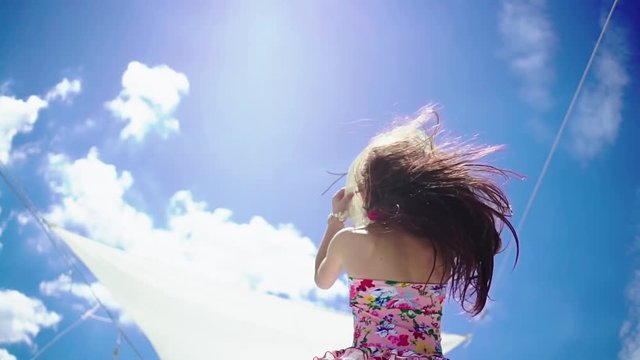Young preteener girl dancing on sunny day