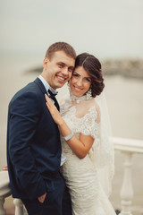 Beautiful wedding couple on a walk near water