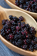 Blackberries in wooden baskets on a table