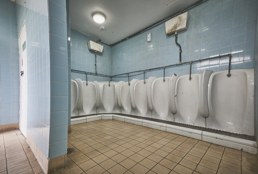 Empty old fashioned public toilets and urinals
