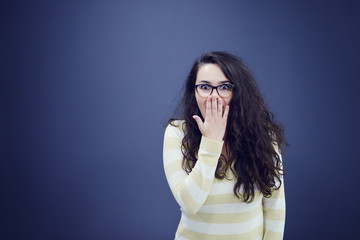 Secretary or business woman with suprised look on her face isolated over dark background