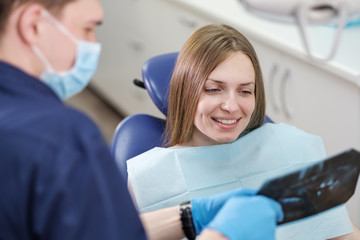 Girl patient of a dentist doctor close-up watching an x-ray