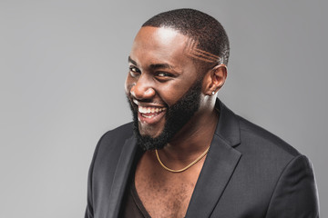 Cheerful successful young  African American man studio portrait in full suit