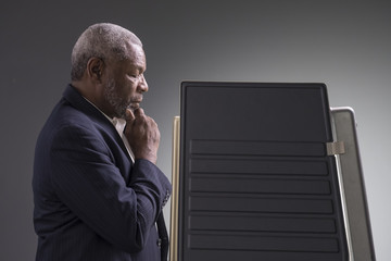 Portrait of a black man standing in a voting booth