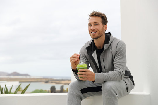 Healthy Man Drinking Green Smoothie At Home Terrace. Sport Athlete With Spinach Cold Pressed Juice Plastic Cup Drink Relaxing Outdoors.