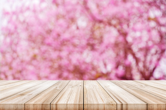 Empty Wooden Table Top With Blurred Pink Cherry Or Cherry Blossom Background.