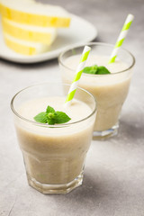 Cantaloupe melon mint smoothie. Beautiful summer drinks concept. Selective focus, copy space.