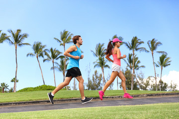 Sport fitness runners couple running lifestyle. Healthy people jogging together in summer city park outdoor, athletes training cardio on sidewalk. - Powered by Adobe