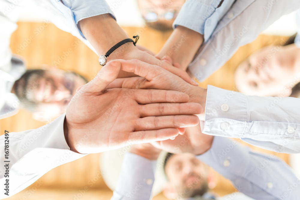 Wall mural stack of hands. unity and teamwork concept.
