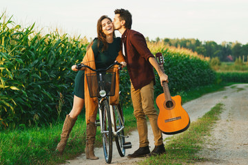 Young couple is walking by country road