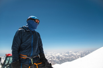 Professional guide - climber on the snow-covered summit of Elbrus sleeping volcano