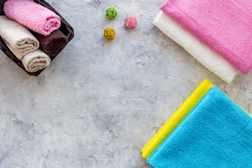 Linen after washing. Clean towel on grey stone background top view copyspace