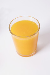 glass with natural orange juice on white background