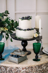 beautiful decorate table with candles and wedding cake on the table in studio
