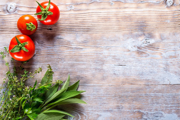 tomatoes spices and basil on wooden background, copy space