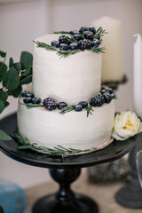 beautiful decorate wedding cake with candles and flowers