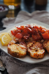 Fried cod with rice and pepper on a plate