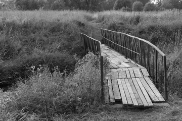 Old curved bridge in the countryside - black and white