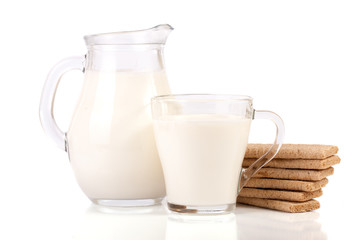Obraz na płótnie Canvas jug and glass of milk with stack of grain crispbreads isolated on white background