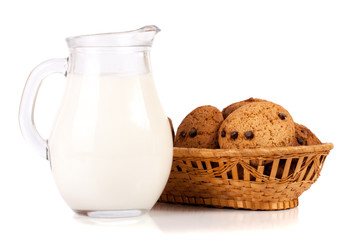 jug of milk with oatmeal cookies in a wicker basket isolated on white background