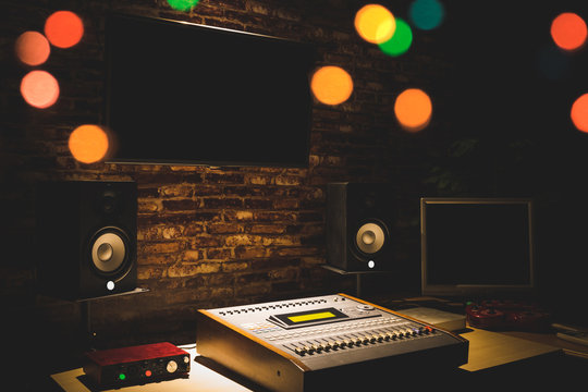 digital sound mixer, monitor speakers & LED screen in recording studio. music production