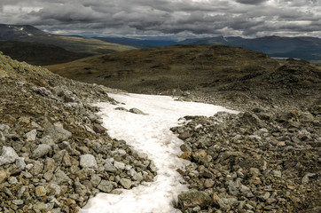 Snow in Jotunheimen park at the Besseggen route. Fantastic view over the highest mountains of Norway