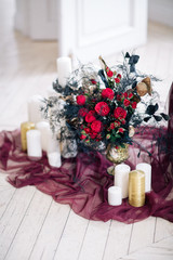beautiful decorate wedding bouqet near sofa with candles and in studio