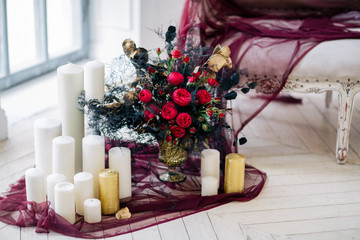 beautiful decorate wedding bouqet near sofa with candles and in studio