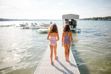 Two young girls walking along jetty