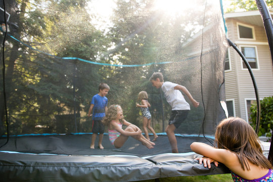 Young children playing on trampoline