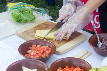 Hands cooking burrito