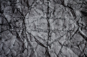 Crumpled black and white paper (as a paper background or paper texture)