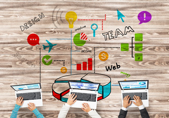 Top view of businesspeople sitting at table and using gadgets