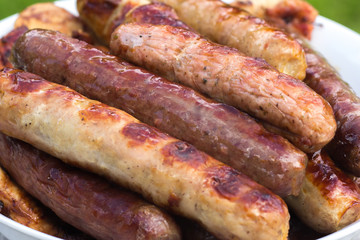 Several freshly prepared sausages. They are prepared on hot coals on the grill.