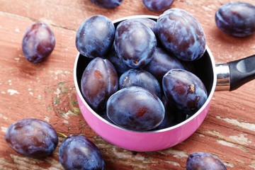Ripe plums in a pan