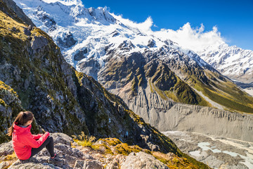 New zealand woman tourist lifestyle hiking in mountains relaxing looking at view of Mt Cook. Alps in South island.
