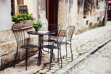 Fototapeta na wymiar Empty chairs in outdoor cafe or restaurant