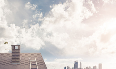Obraz premium Brick house roof and modern cityscape at background