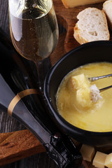 Gourmet Swiss fondue dinner on a winter evening with assorted ch