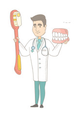 Young caucasian dentist holding dental jaw model and a toothbrush in hands. Happy dentist showing dental jaw model and toothbrush. Vector sketch cartoon illustration isolated on white background.