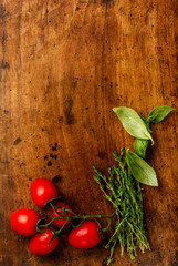 Cooking background with tomatoes, garlic, thyme, basil leaves. Top view.