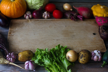 raw organic fresh vegetables and wooden board in rustic style. Harvest time, colorful vegetables,...