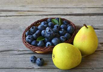 Fresh blueberries and ripe pears on wooden rustic table. Blueberry and pears.Healthy eating,diet and nutrition concept.Selective focus.