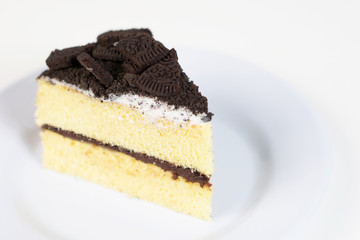 Chocolate cookies oreo cheese cake slice on white dish