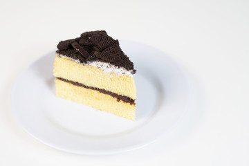 Chocolate cookies oreo cheese cake slice on white dish